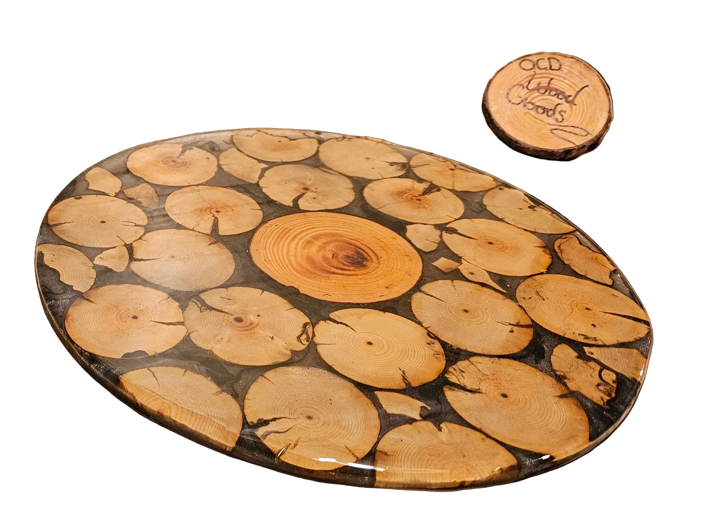 Wooden cutting board with a unique grain pattern and a smaller round wooden brand signon a white background.