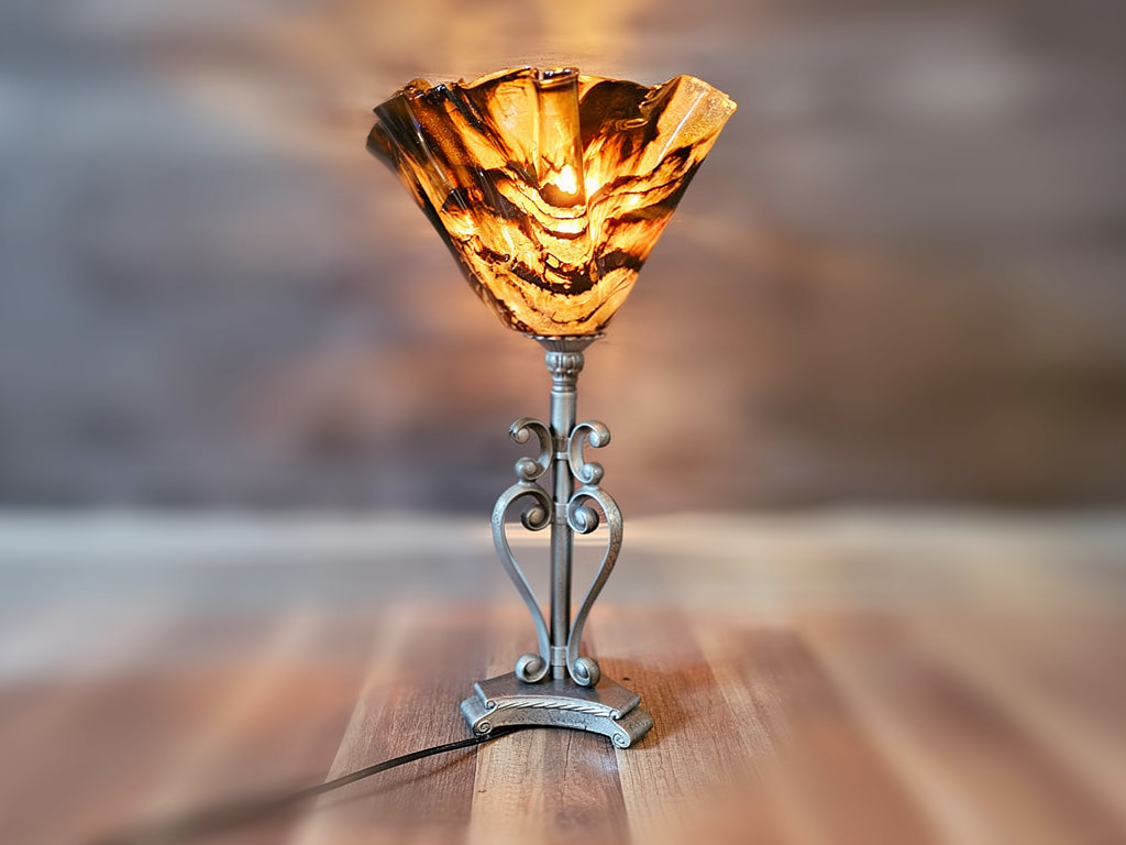 Handcrafted rustic lamp. Wood/resin construction with antique hammered metal finish. Gold/black detail shade.